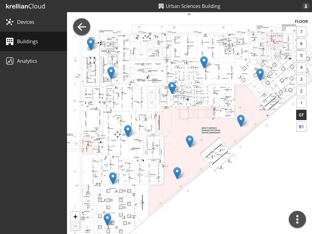 A mockup of a user interface showing devices represented as pins overlayed on a zoomable floor plan